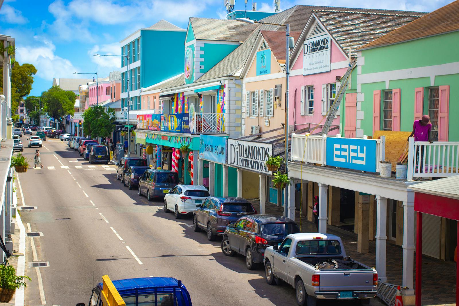 Colorful shops and local life on a sunny street in Nassau, Bahamas.